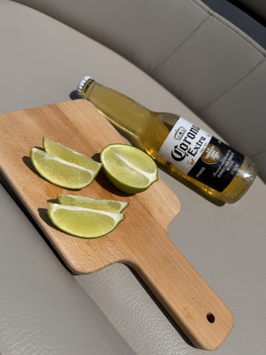 A Corona and cut limes on a cutting board