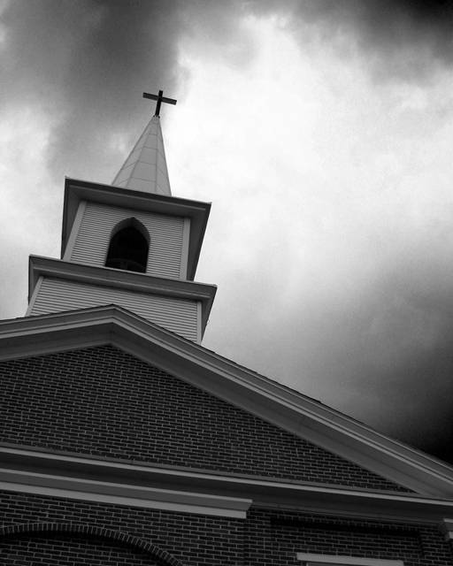 Church steeple against storm clouds
