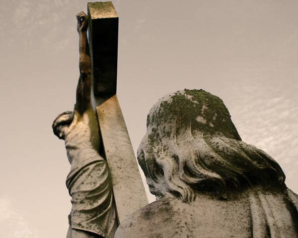 Stone statue at the cross