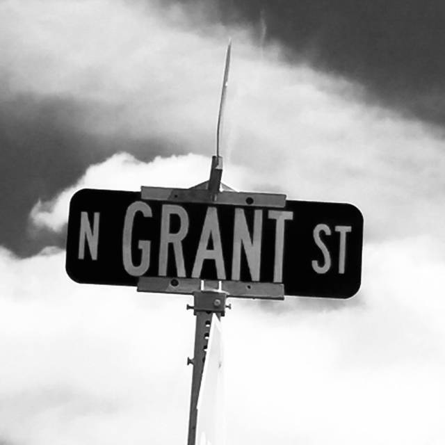 N Grant St sign against clouds