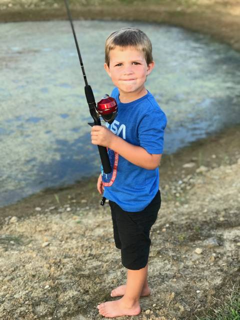 Carter fishing at the water's edge