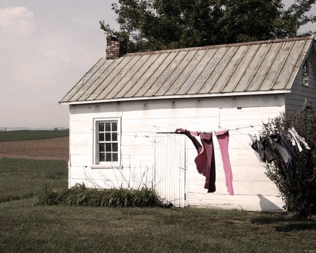 Wash hanging outside a white farmhouse