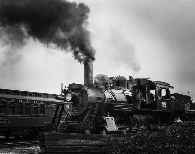 Steam locomotive under a column of smoke