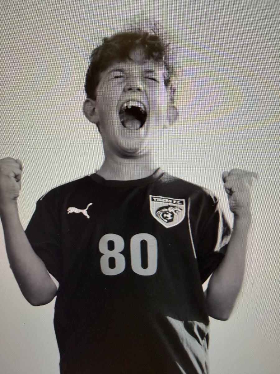 Carter celebrating on the soccer field, black and white